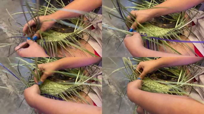 女性手工编织技能，使用干燥和染色的芳香螺旋木或香草草制作农民的帽子。近距离