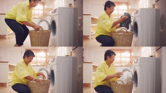 亚洲老年妇女把脏衣服放进洗衣机。有魅力的成熟的老管家清洁工，在家里用洗衣机洗衣服时感到很开心。家政概