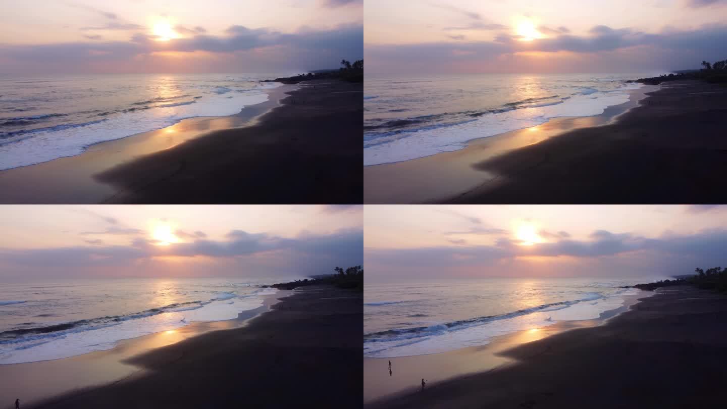 空中4K无人机镜头:迷人的日落在塞塞海滩，巴厘岛;海浪拥抱海岸线，棕榈树在暮色中摇曳;非常适合冥想、