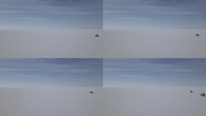 无人机拍摄的一辆4x4越野车行驶在乌尤尼盐湖周围的鱼岛，在玻利维亚安第斯山脉高海拔地区世界上最大的盐