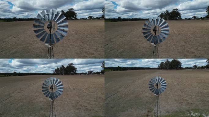 在多云的日子里，玛格丽特河地区的农场上旋转风车的空中向后拍摄