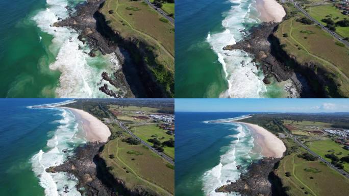 澳大利亚新南威尔士州巴利纳的夏普海滩，旁边是怀特的头和平坦的岩石。空中