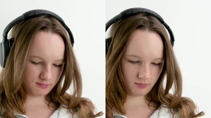 在手机的播放列表中搜索合适的音乐，十几岁的女孩戴着耳机选择一段旋律听风运动服在一个白色的背景
