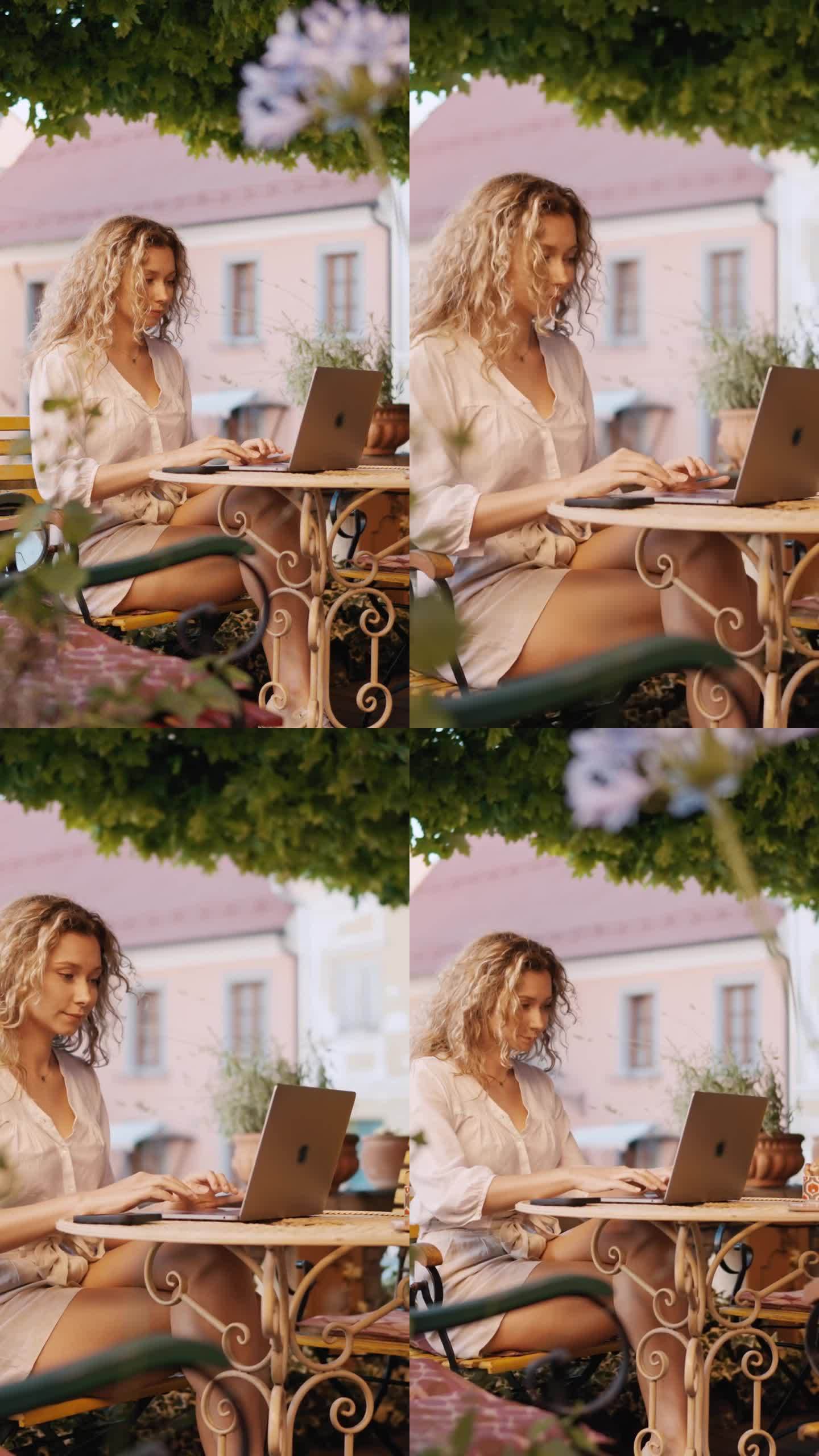 在Ptuj - VERTICAL老城的户外咖啡馆里，放松的年轻女游客使用笔记本电脑