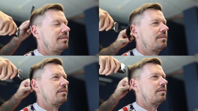 理发师用剪子给年轻人理发，并把头发梳在头上