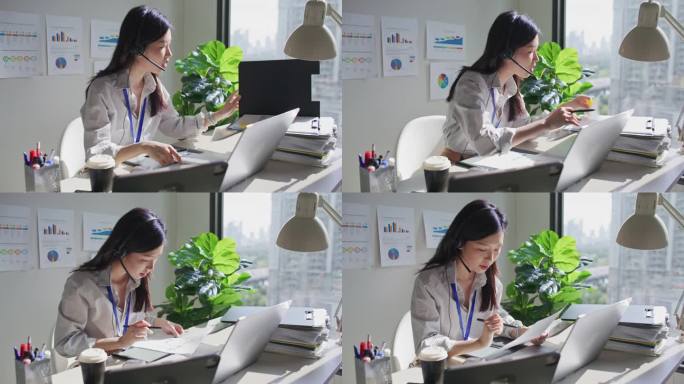 亚洲女商人戴着耳机用笔记本电脑开会