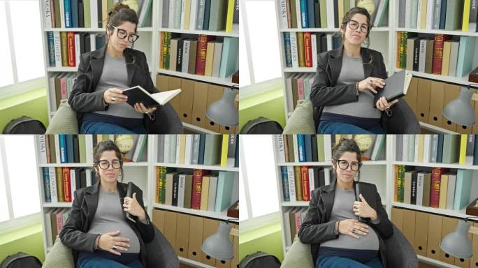 在图书馆大学，年轻的怀孕女学生拿着书摸着肚子
