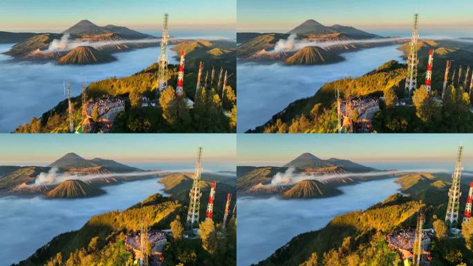 空中无人机拍摄的印尼爪哇岛东爪哇岛腾格里火山口喷发火山Bromo火山的日出场景，周围有云、雾和烟，还