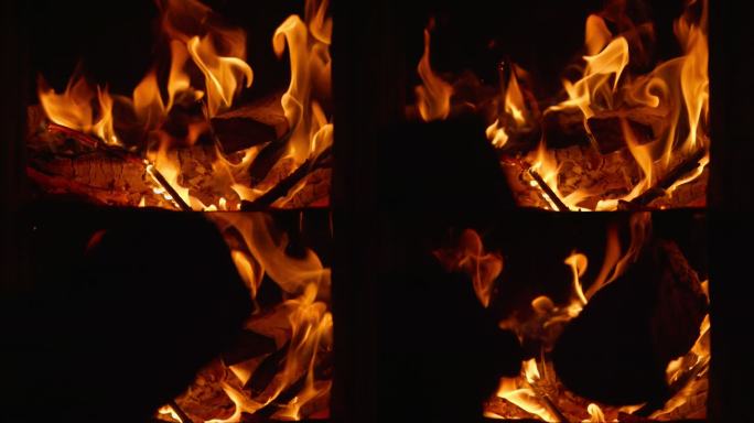 往篝火里添加木柴火焰升格慢镜头