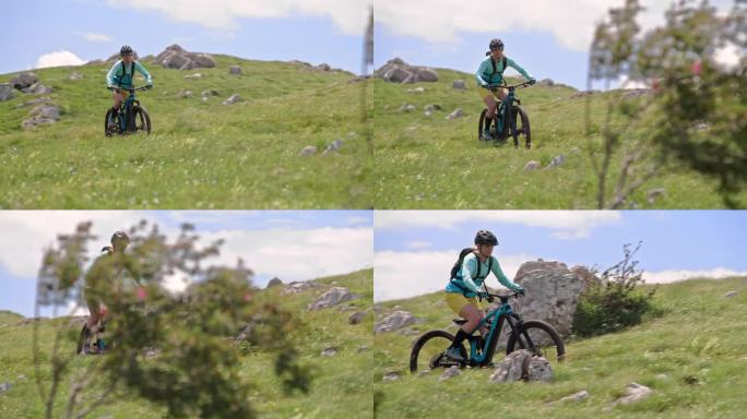 一名女子在阳光下的山上骑着她的电动自行车
