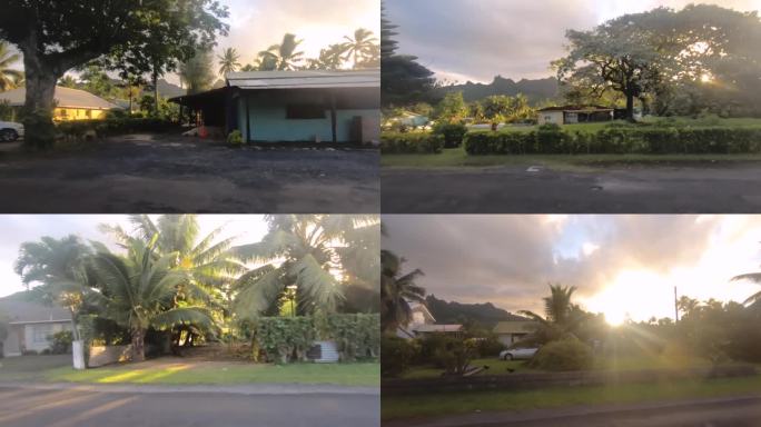 库克群岛拉罗汤加- 2020年6月5日:在多云的日落时分，阳光普照，远处的西侧街景和当地社区商店可以