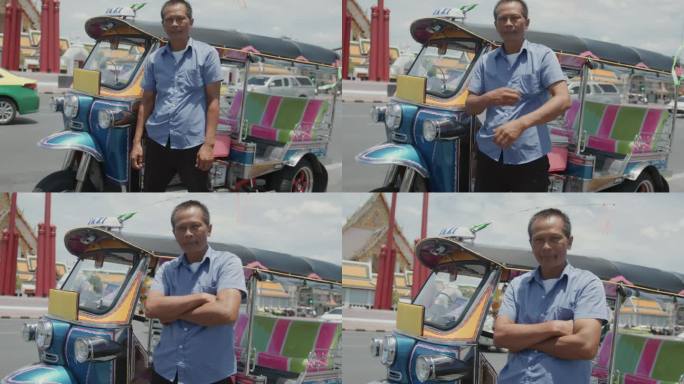 在曼谷老城区，嘟嘟车司机双手交叉站在路边的肖像。