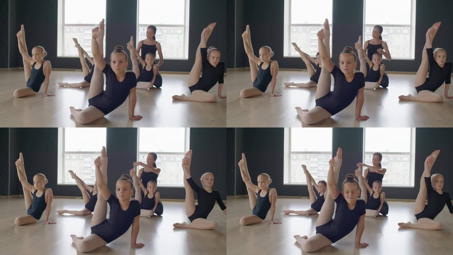 老师帮助女孩们做体操姿势