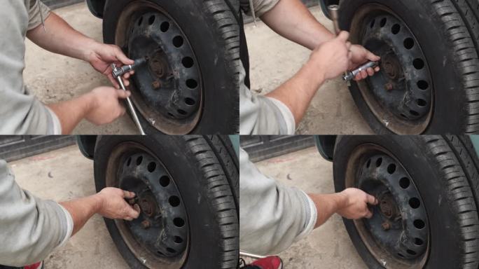 专业的汽车修理工拧下了汽车左前轮的螺丝。
