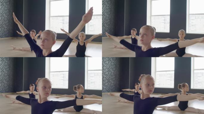 芭蕾舞演员在工作室用手臂做向下的圆周运动