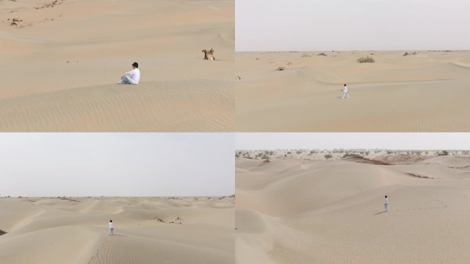 航拍男人走在新疆塔克拉玛干沙漠中