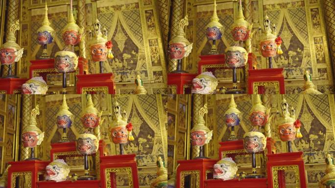 美丽的古代传统泰式图案的侧视图哑剧或孔夫子面具被设置在各种风格的人物木制架子上。