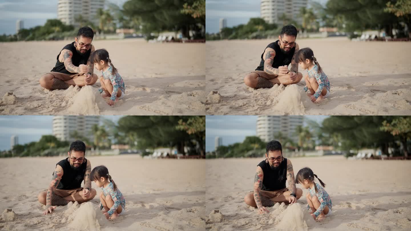 快乐的亚洲父亲和蹒跚学步的女儿周末在海滩上搭沙堡