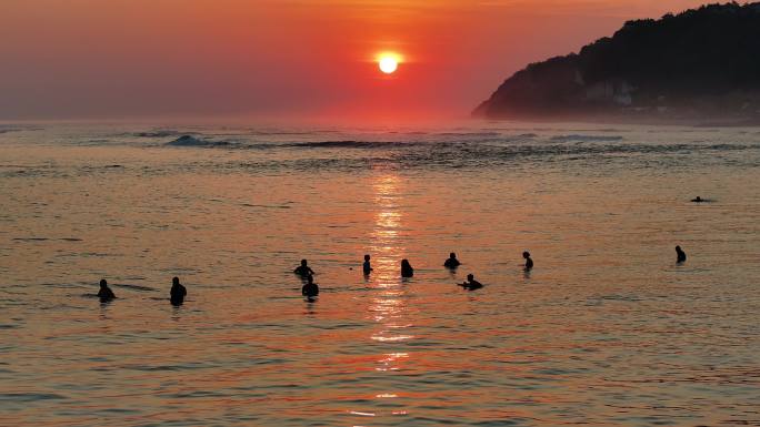 夕阳下海平面上冲浪的自由浪人