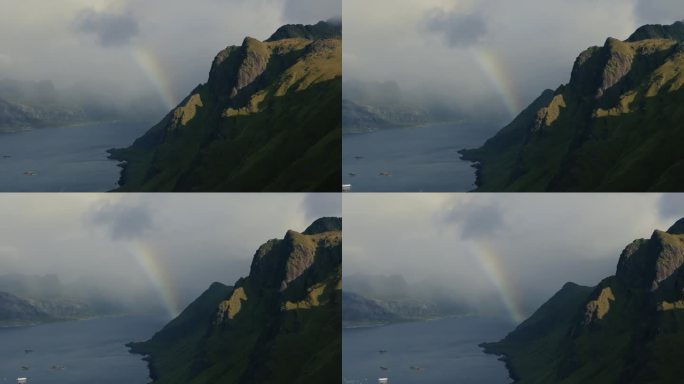无人机飞过岩石峡湾，在水面上的云层中露出彩虹