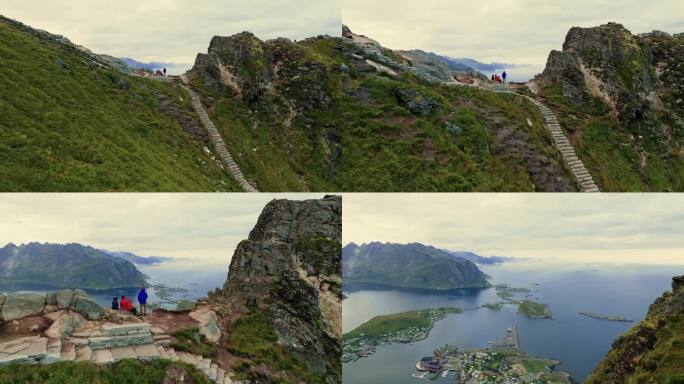 无人机飞过站在峡湾顶部的旅行者家庭，观察下面渔村的壮丽景色。