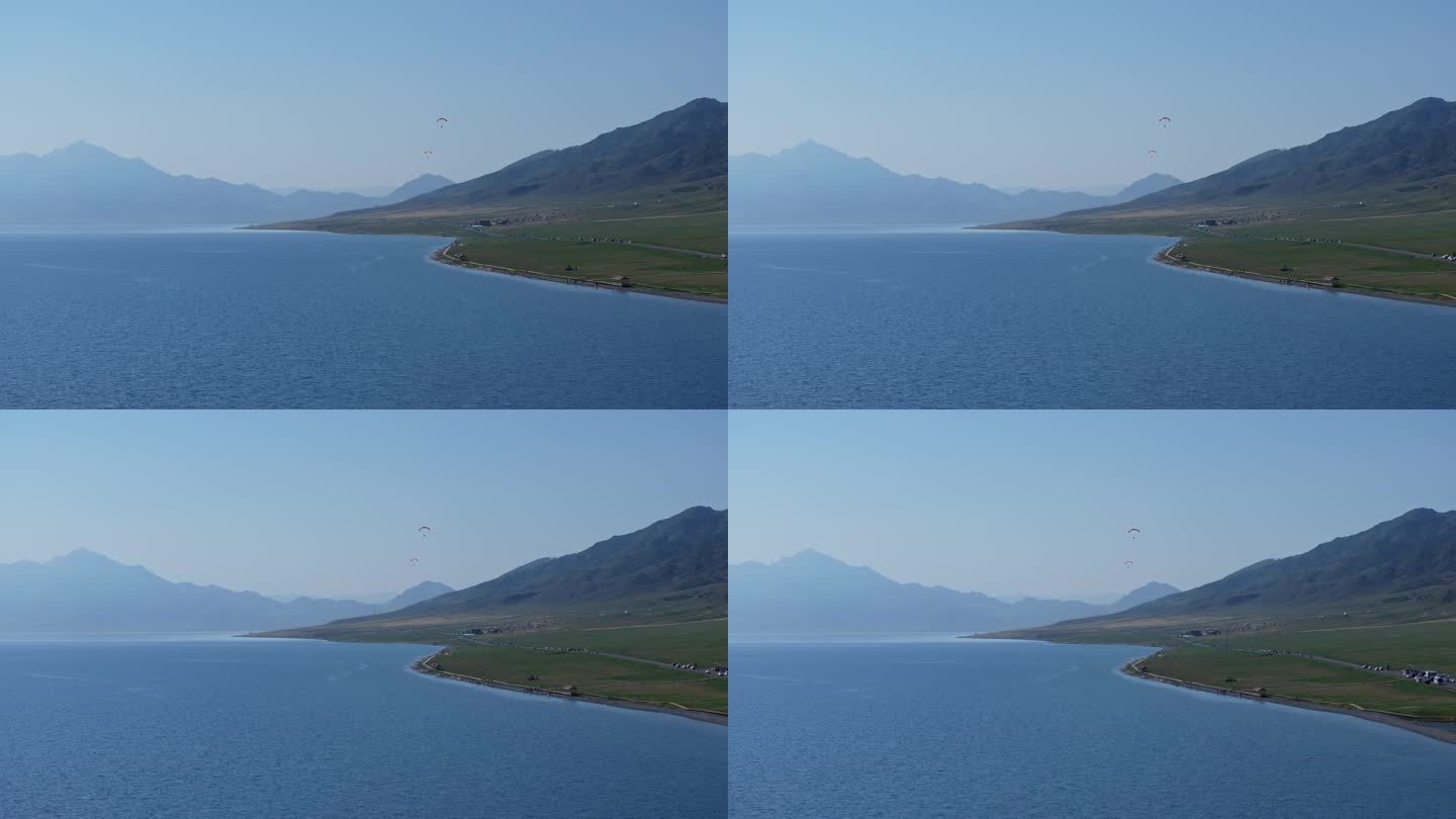 航拍夏天新疆赛里木湖的动力滑翔伞