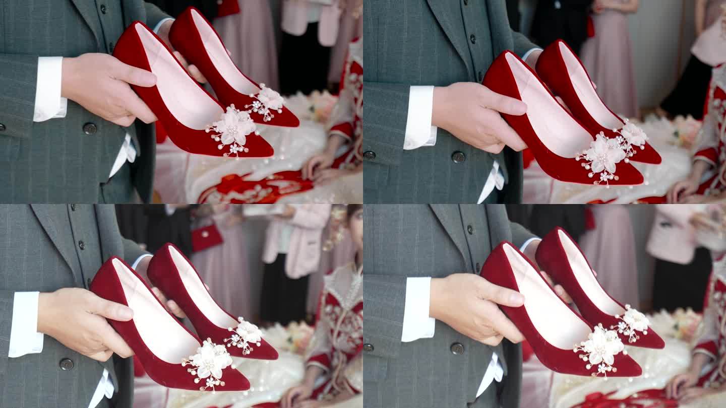 男人手里的红色婚鞋