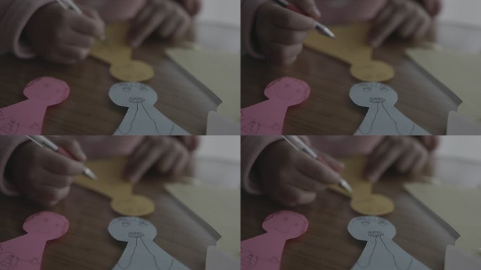 小孩画画剪纸彩色小纸人双手画线条儿童画