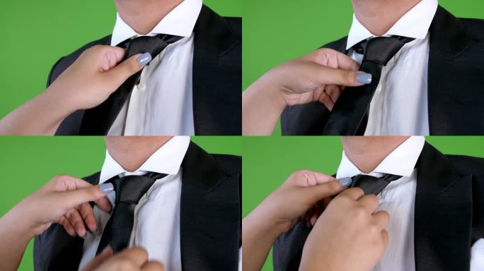 年轻女子帮丈夫系领带，绿幕背景，特写镜头，系领带