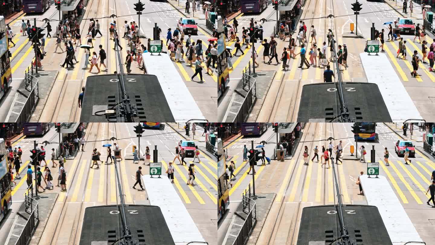 在香港铜锣湾购物区，游客走过斑马线。