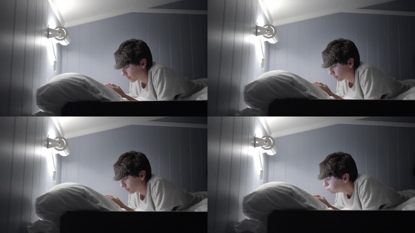 视频4k PRORES HQ。帅气的少年躺在卧室的床上玩电子游戏机。他有很多毒瘾。