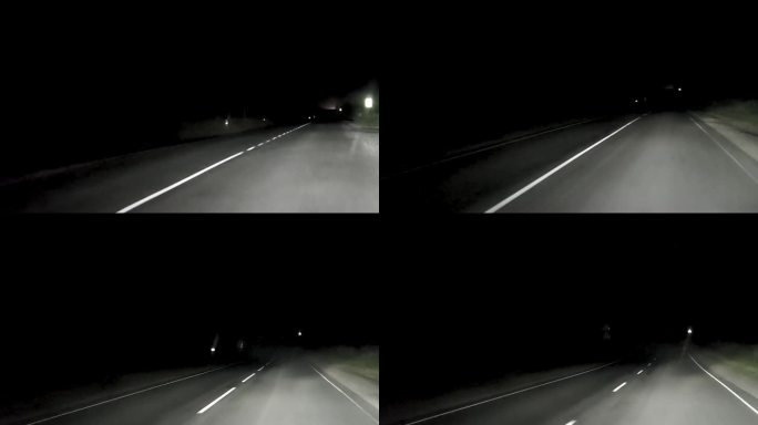 夜路。使用远光灯的汽车在乡村道路上夜间行车的视角
