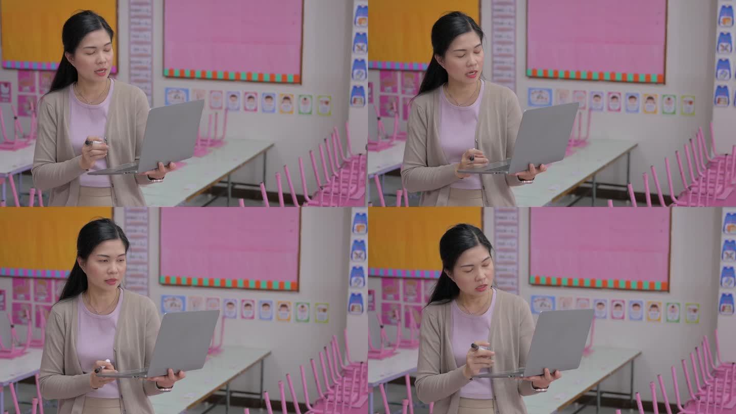 年轻的亚裔女老师在学校的白板上写字，在学校的课堂上教学生
