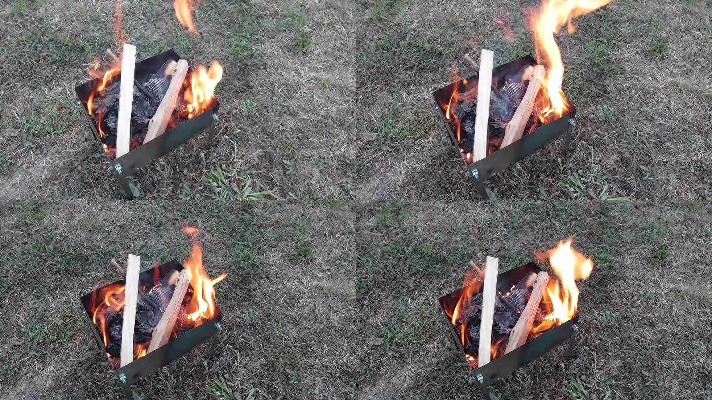 引燃羊肉串柴火的金属火盆