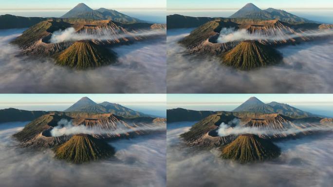 空中无人机拍摄的印尼爪哇岛东爪哇岛腾格里火山口喷发火山Bromo火山的日出场景，周围有云、雾和烟，还