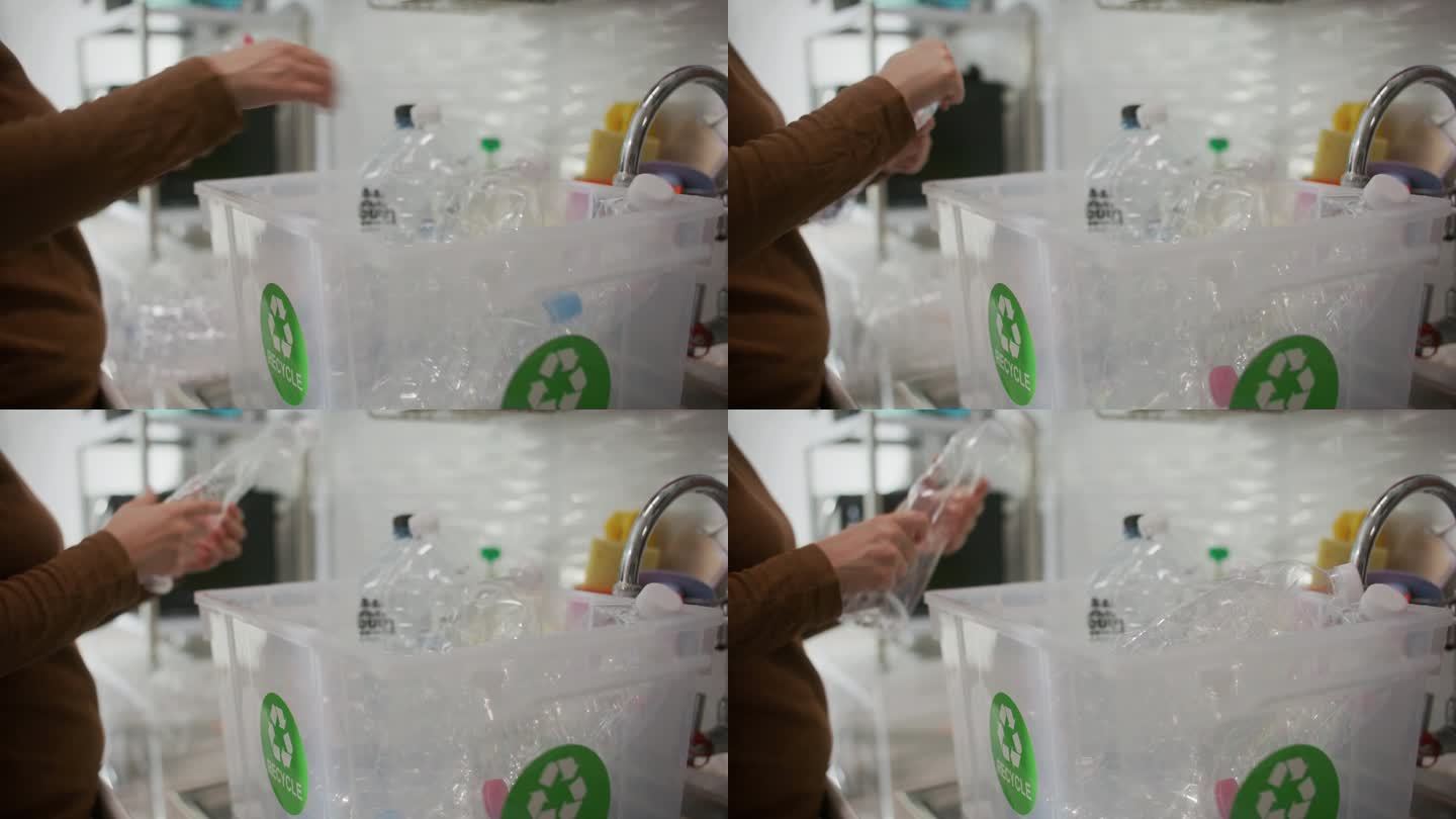 回收瓶装水，妇女在家厨房废弃塑料瓶