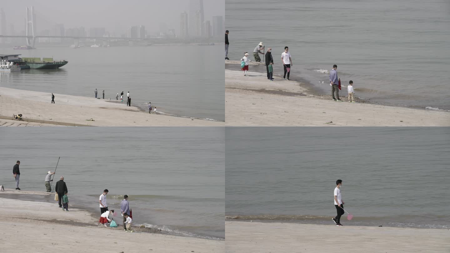 武昌江滩上在江边捞鱼玩耍的人