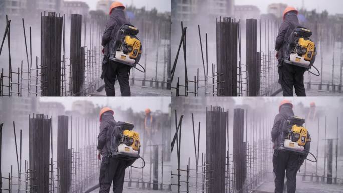 工人使用燃气鼓风机清理建筑工地
