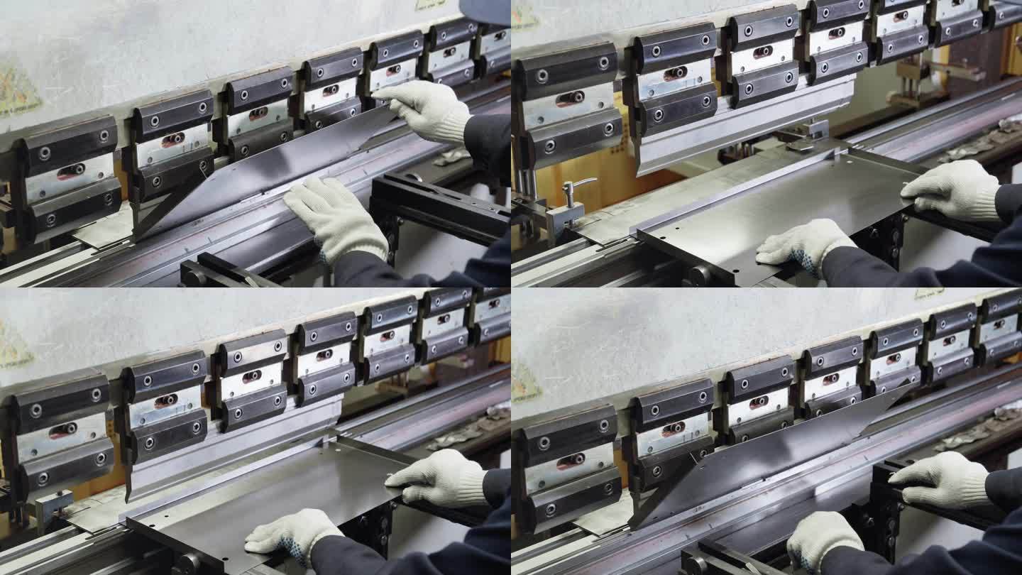 工厂工人把金属片放进折弯机。工业折弯机。