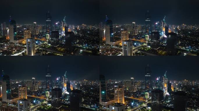 飞越雅加达市中心的夜间照明航拍全景4k延时拍摄印度尼西亚