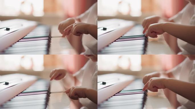 蹒跚学步的男孩用手指在模糊的背景上弹钢琴