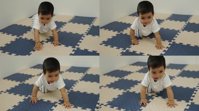 婴儿在游戏垫或拼图地板上爬行