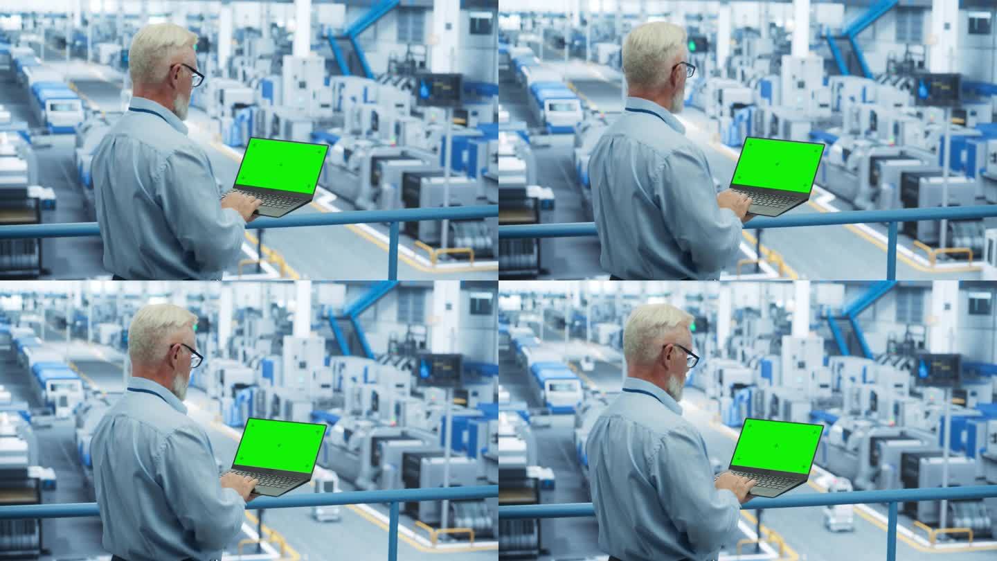 电子制造项目经理在工厂用绿屏模板操作笔记本电脑。中年专家开发，维护，升级机器生产程序
