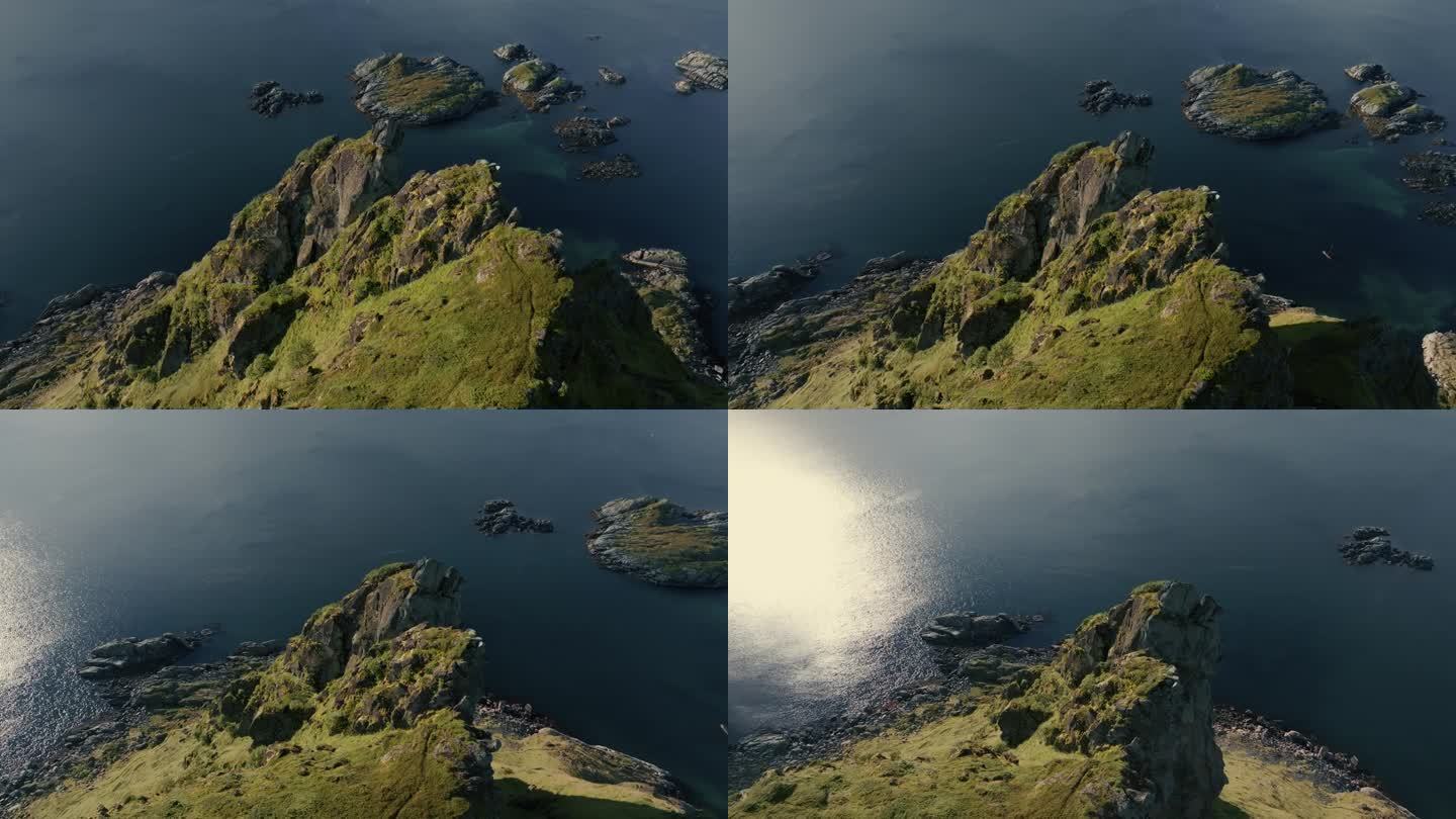 360度的绿色岩石峡湾，山峰和挪威海被阳光照亮