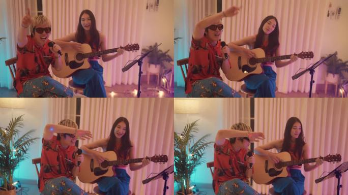 晚会之夜，两个朋友和多民族朋友一起在房间里弹吉他，开心地唱歌。
