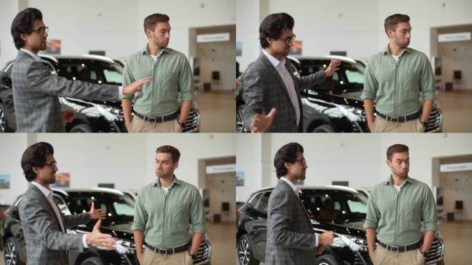 穿着西装的有能力的男性汽车经销商在展示厅与严肃的年轻客户交谈的肖像。可疑的顾客