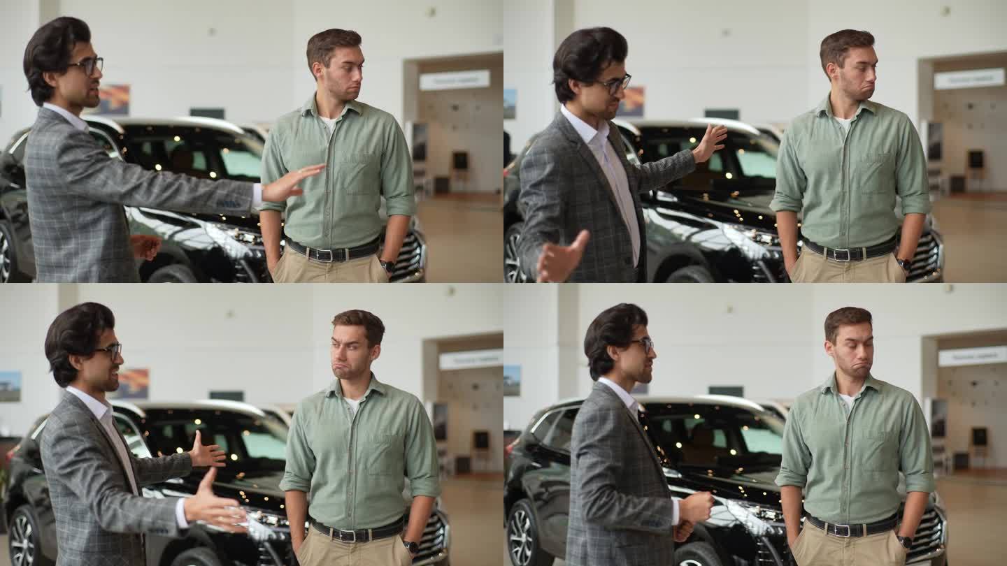 穿着西装的有能力的男性汽车经销商在展示厅与严肃的年轻客户交谈的肖像。可疑的顾客
