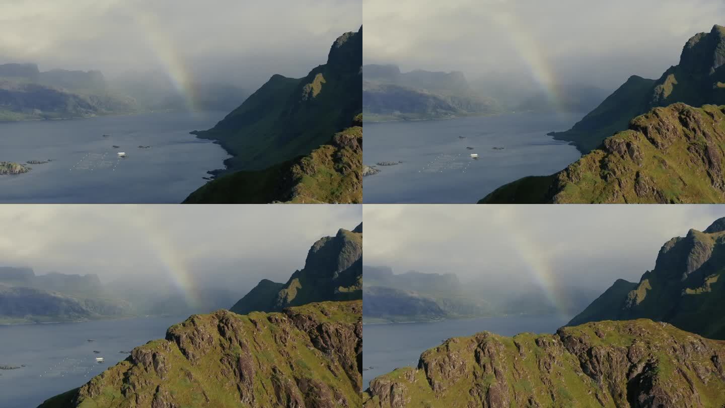 在挪威罗弗敦的绿色岩石峡湾之间，海面上色彩鲜艳的彩虹
