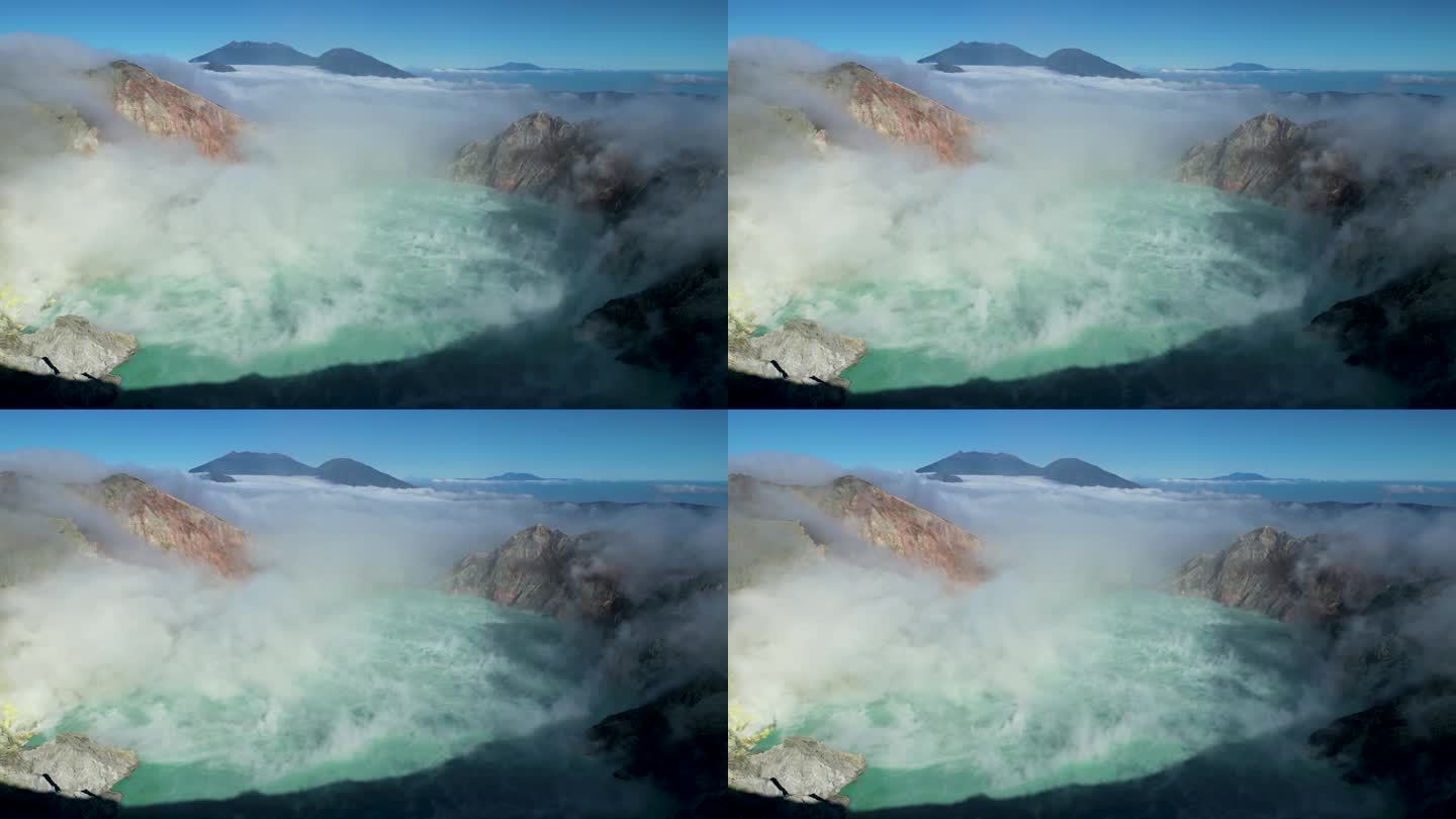 在一个阳光明媚的日子里，著名的伊真火山和它的蓝色湖酸性火山口在空气中喷出烟雾的鸟瞰图-东爪哇-印度尼