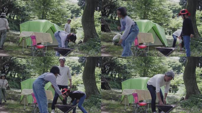 日本的兄弟和姐妹把树枝放在一起作为露营的火坑